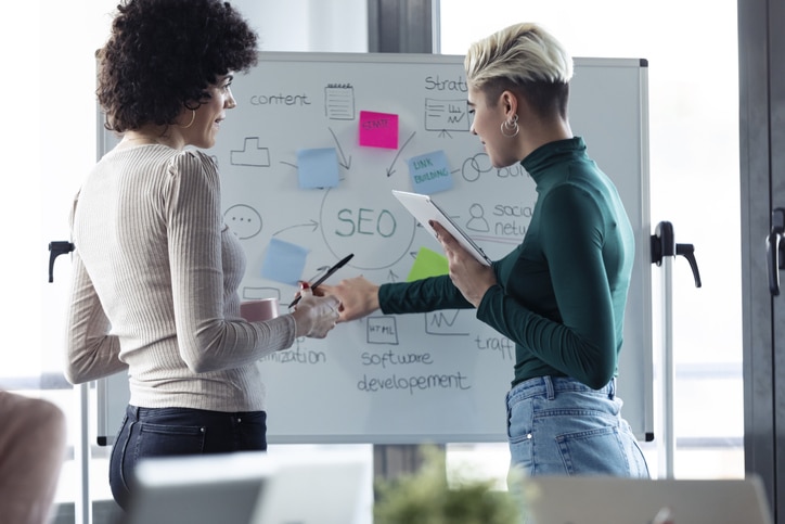 Businesswomen at a flipchart, presenting ideas for a search engine optimisation
