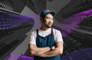 A man in a blue apron standing in front of a building background and purple swirls