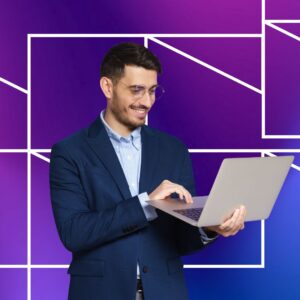A man holding a laptop in front of a purple and blue geometric background