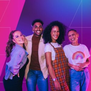 Four young adults stand close together, smiling and laughing toward the camera against a vibrant pink and purple gradient background with geometric line accents, conveying a sense of connection, joy, and inclusivity.
