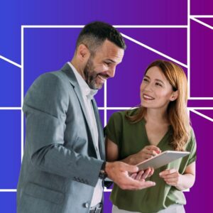 Two professionals smile while reviewing information on a tablet together, standing against a blue and purple gradient background with geometric white line patterns, suggesting collaboration and digital strategy planning.